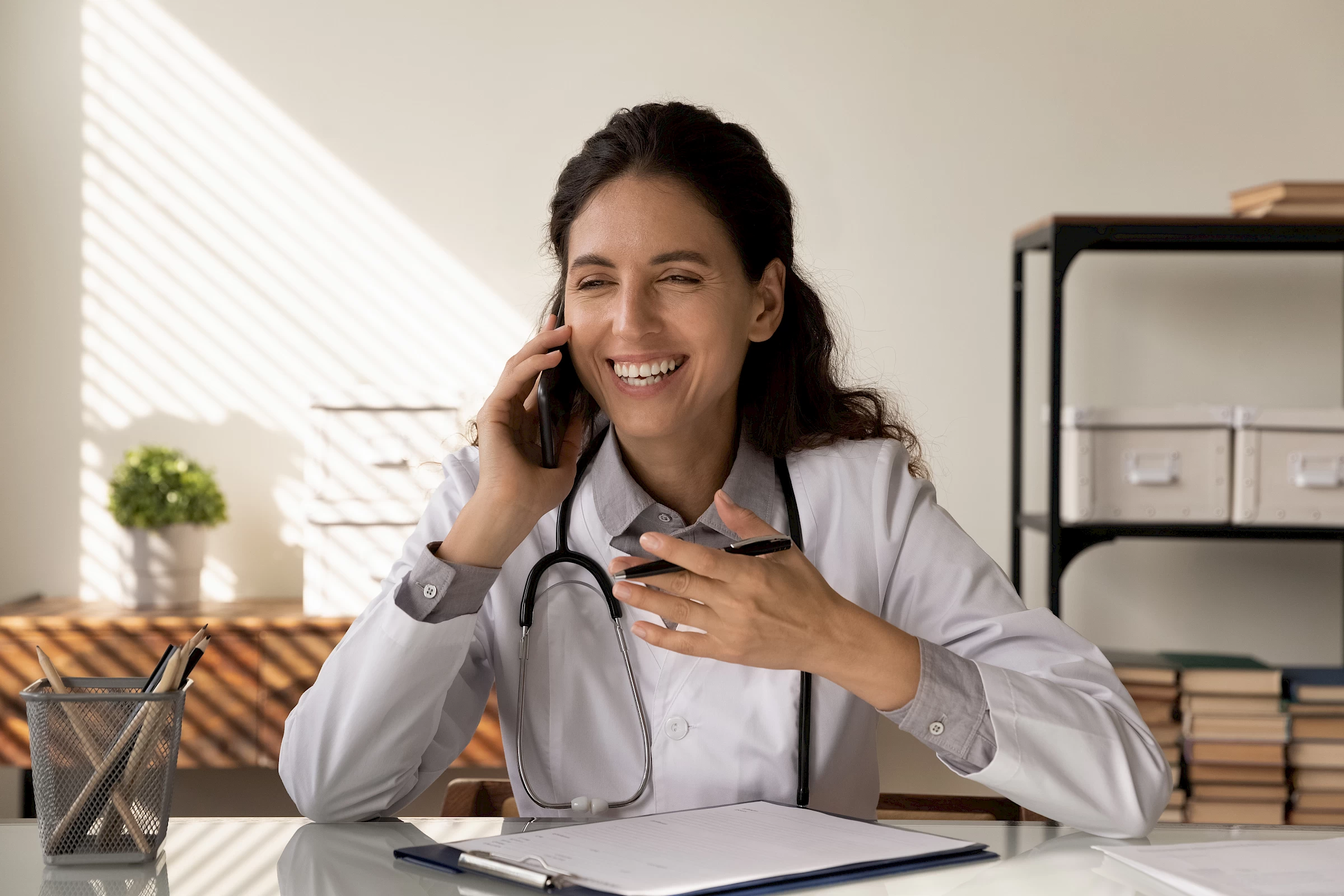 A doctor on the phone in her office