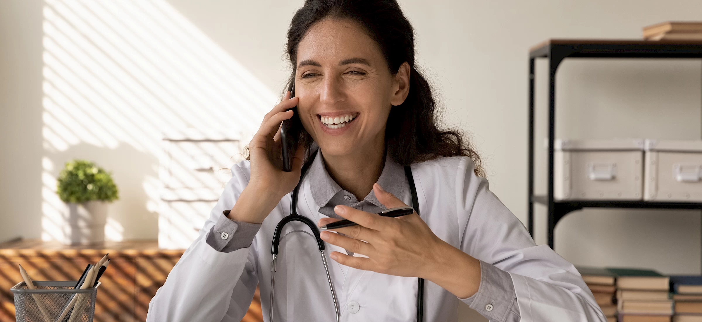 A doctor on the phone in her office